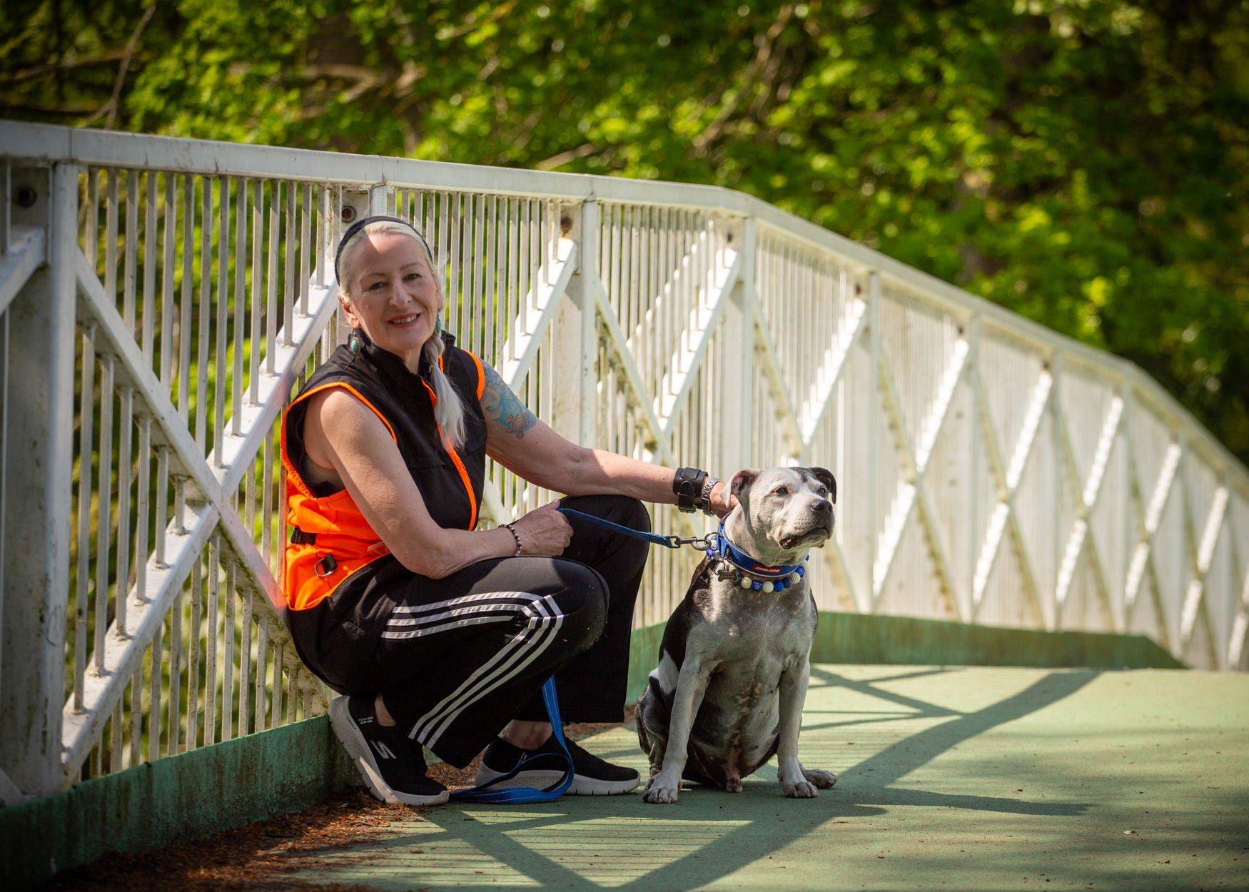 Anna with her dog Denzel on a bridge in Lincoln