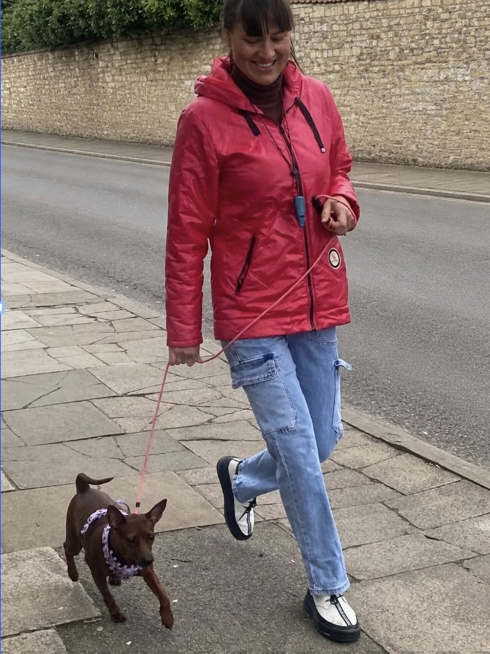 A client walking her miniature dachshund calmly on a Lincoln street